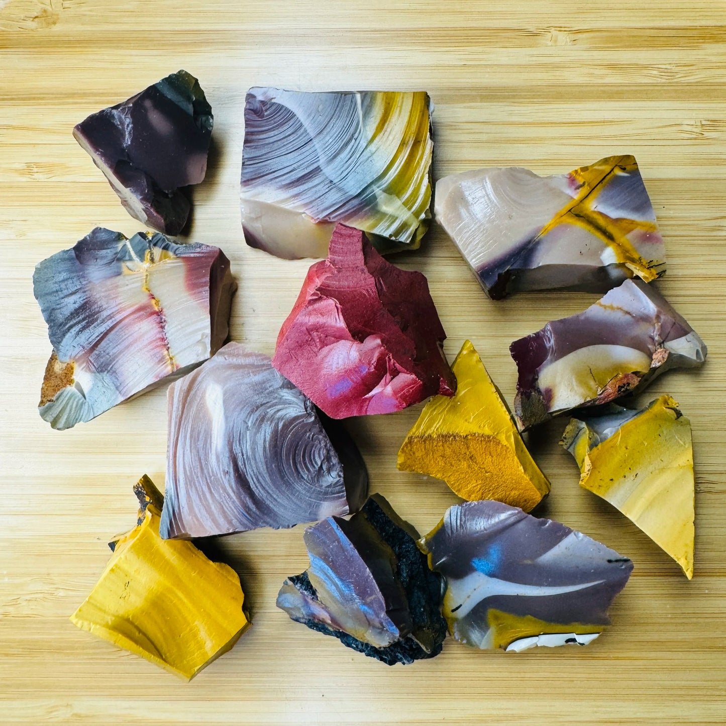 Unpolished Mookaite pieces showing warm earth-tone banding, Western Australia, 1 to 2 inch