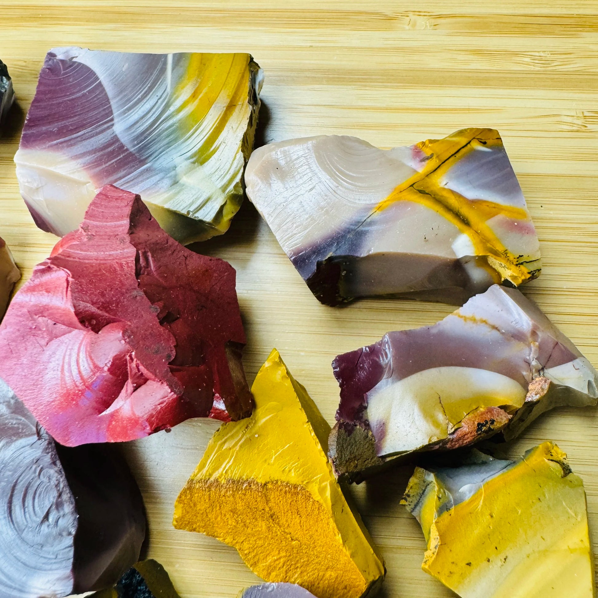 Grouping of raw Mookaite jasper, Grade AA, natural ochre and burgundy patterning