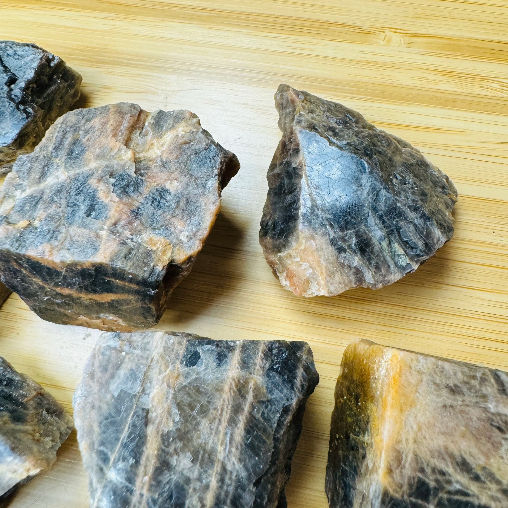 Scale reference of one Black Moonstone raw stone for scale, hand-selected from Amoron'i Mania, Madagascar.