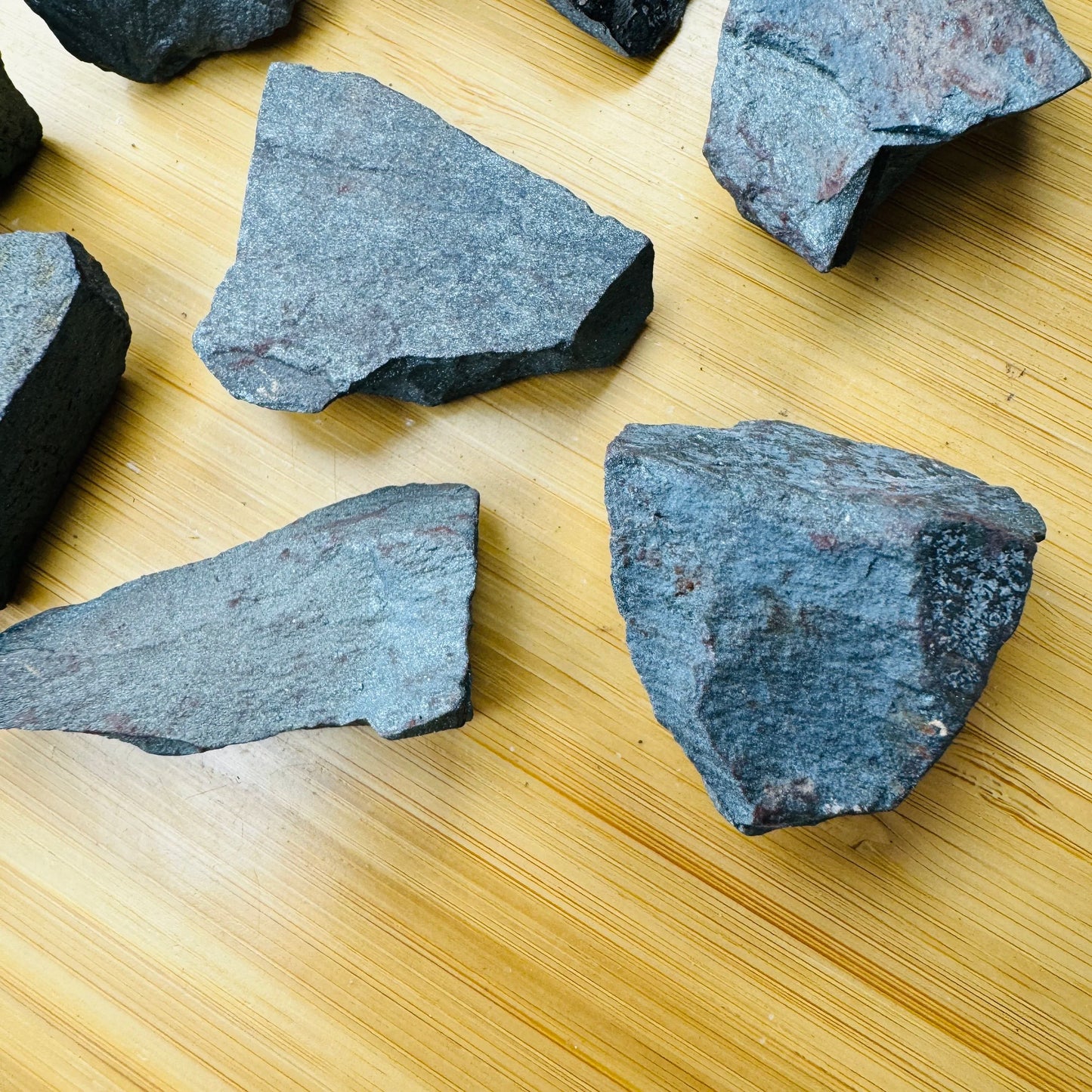 Edge-on view of gray Hematite raw stone, for Grounding, from Minas Gerais, Brazil.