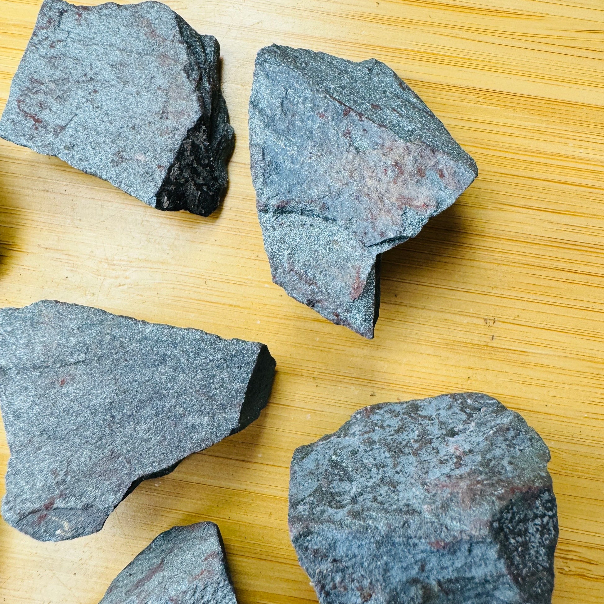 Close detail of Grade AA Hematite raw stone, sourced from Minas Gerais, Brazil, carried for Grounding and Protection.