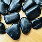 Close-up of Black Tourmaline tumbled stone from Brazil, soothing wellness stone for Stress Relief