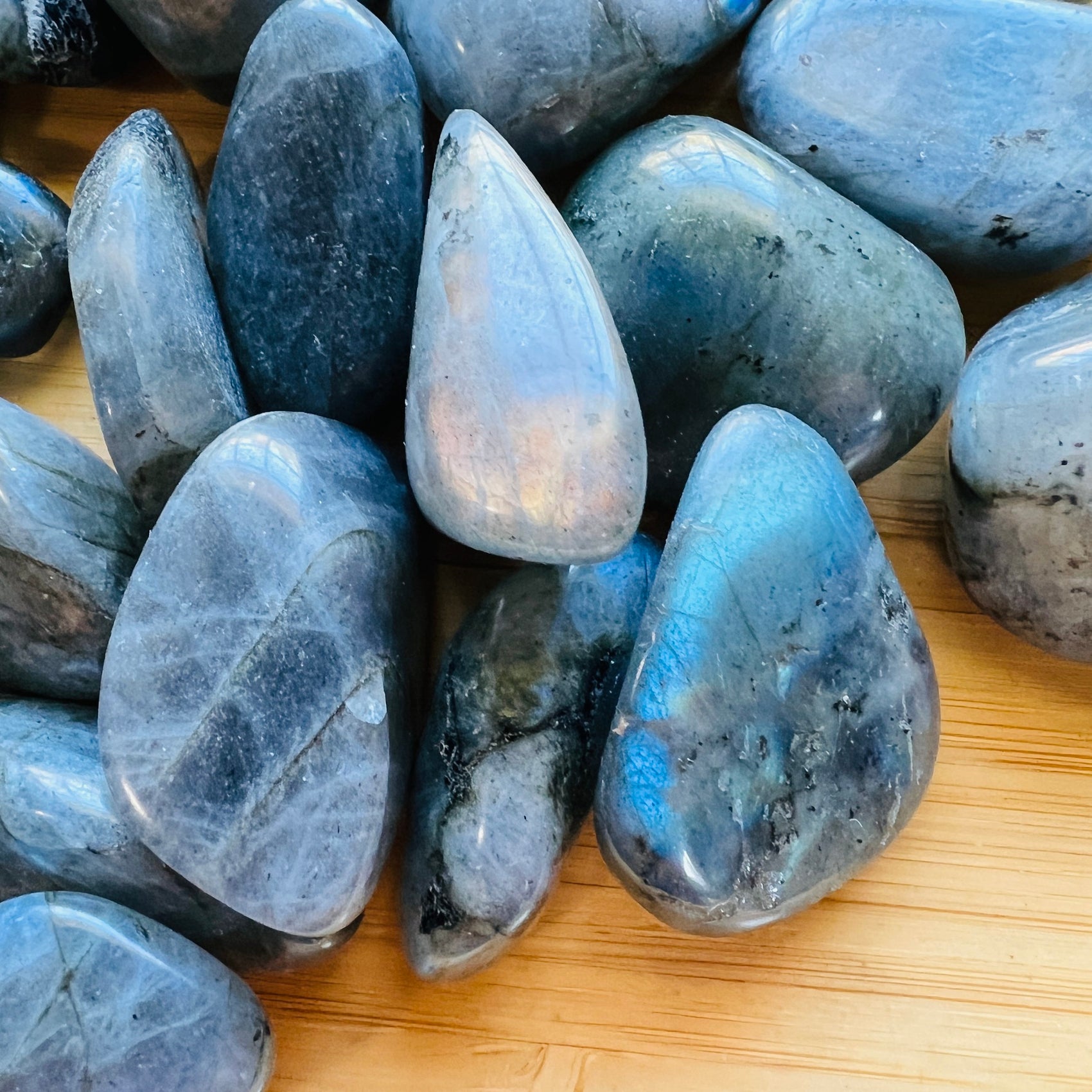 Aerial view of gray Labradorite tumbled stone, showing translucent edges.