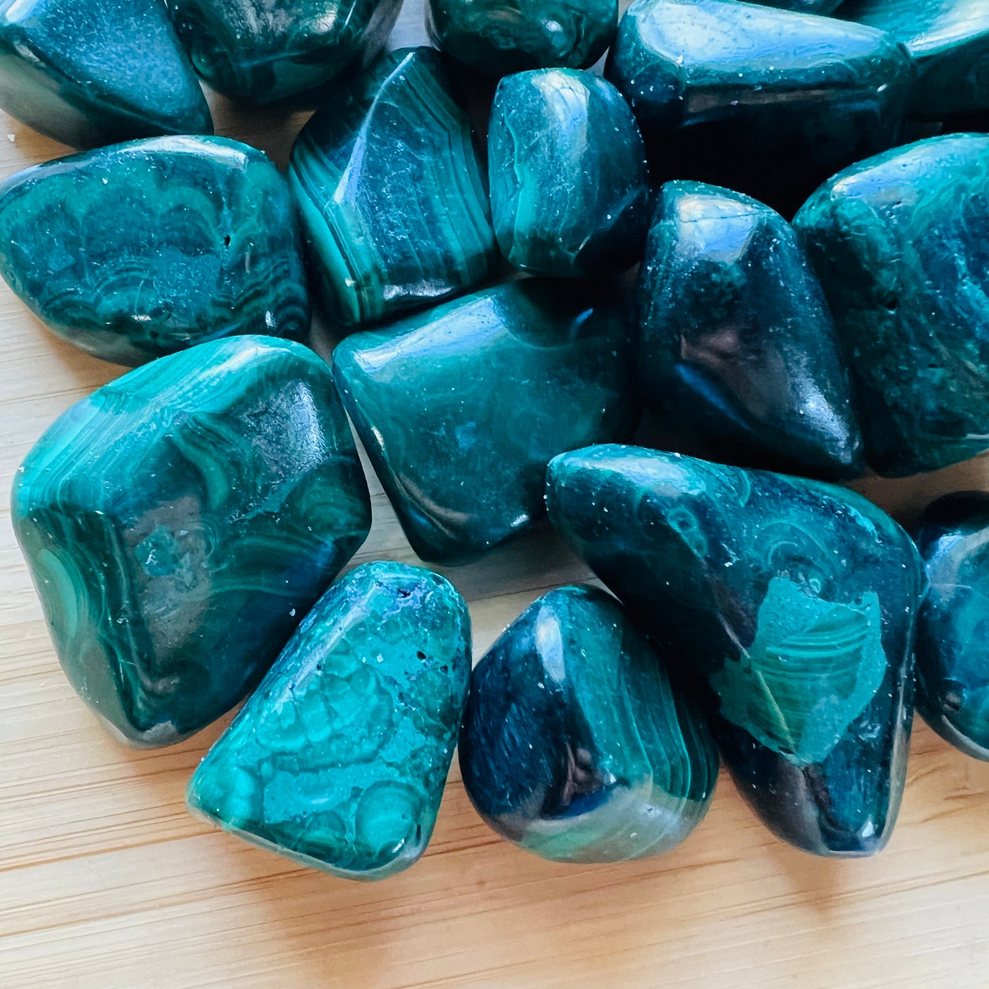 Surface detail of Malachite tumbled stone, showing matte finish.