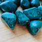 Tight crop of Malachite tumbled stone, from Democratic Republic of the Congo, showing color depth.
