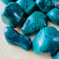Sideways view of Malachite tumbled stone, showing characteristic finish.
