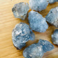 Edge view of Celestite raw stone, showing earthy tone.