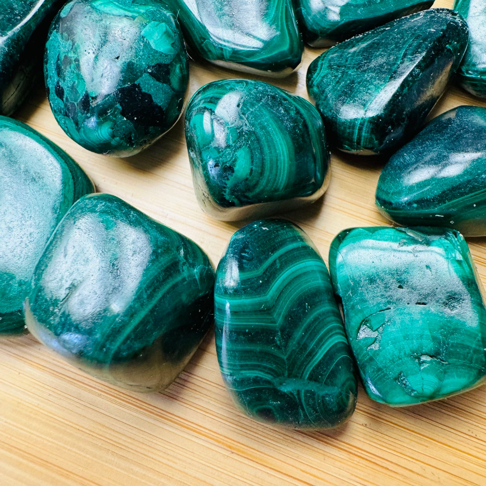 Reverse side of Malachite tumbled stone, showing soft luster.