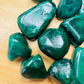 Profile shot of Malachite tumbled stone, showing soft luster, hand-selected from Haut-Katanga, Democratic Republic of the Congo.