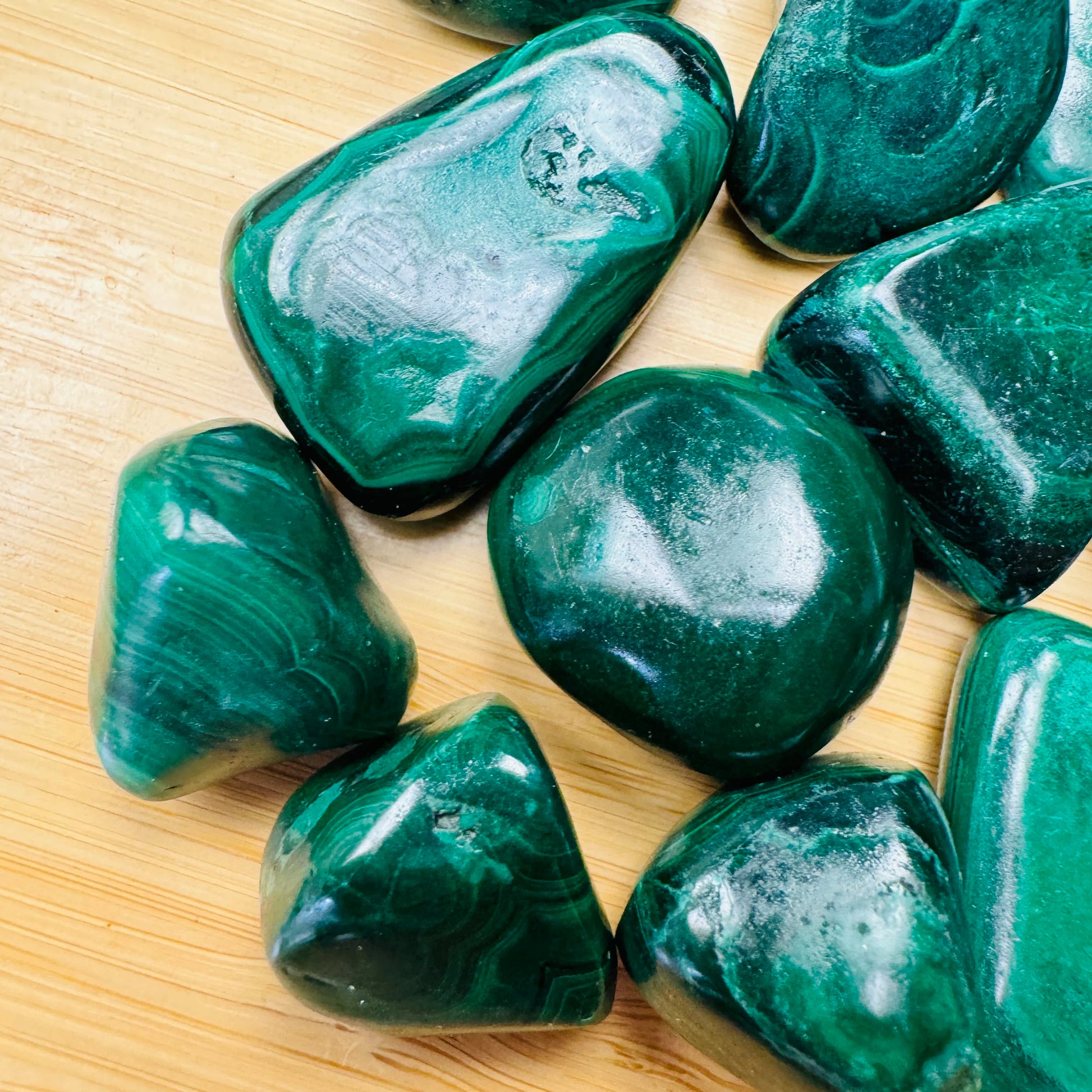 Profile shot of Malachite tumbled stone, showing soft luster, hand-selected from Haut-Katanga, Democratic Republic of the Congo.