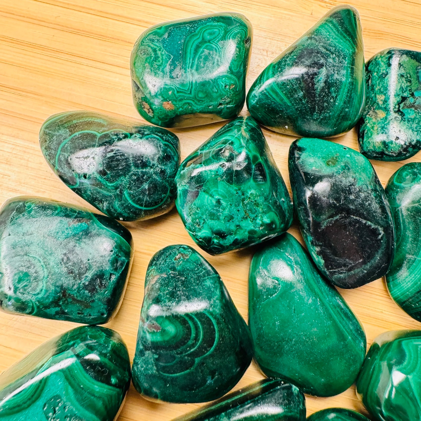 Aerial view of Malachite tumbled stone, Democratic Republic of the Congo-sourced, showing natural variation.