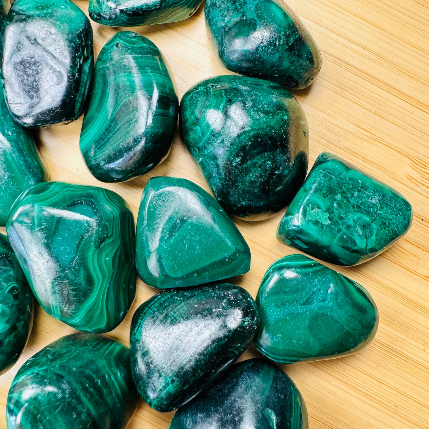 Near view of Malachite tumbled stone, often worked with for Emotional Healing.