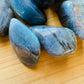 Texture-level view of Labradorite tumbled stone, showing glassy finish.