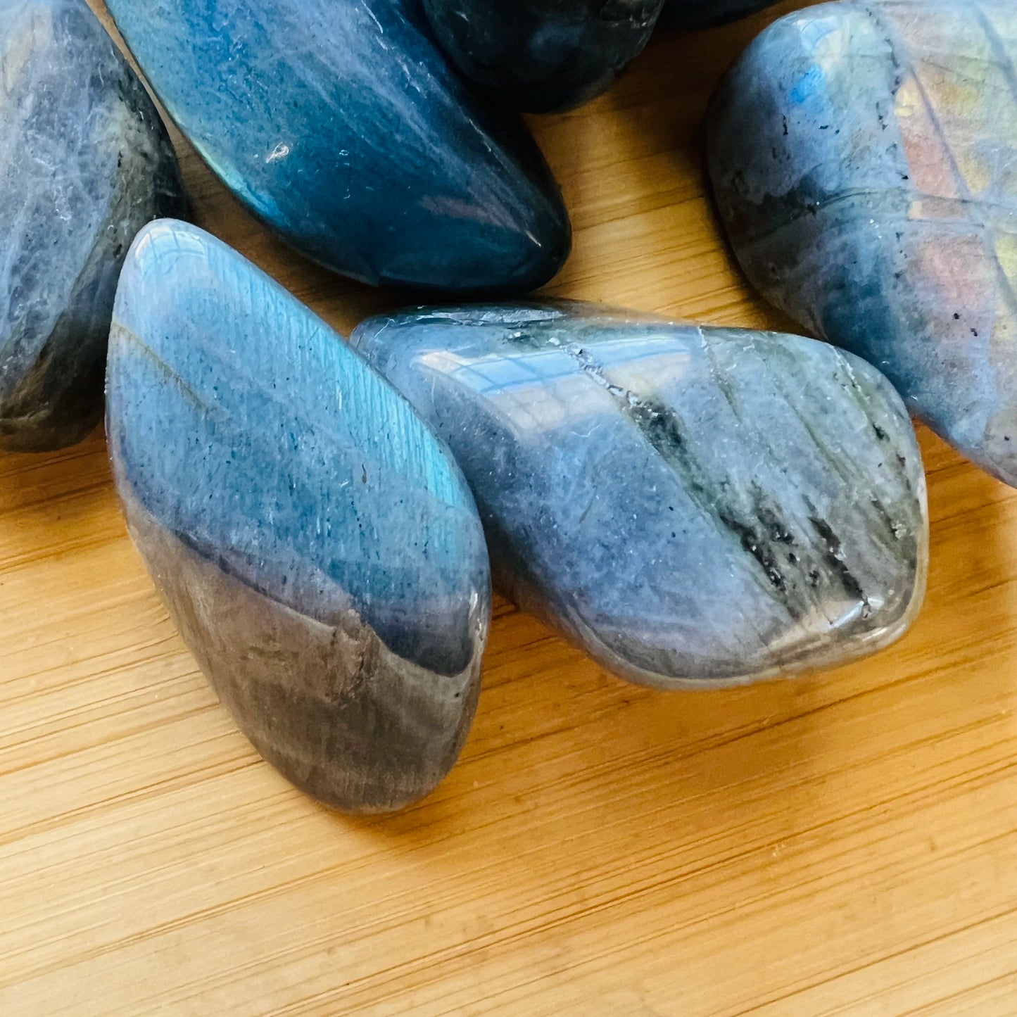 Texture-level view of Labradorite tumbled stone, showing glassy finish.
