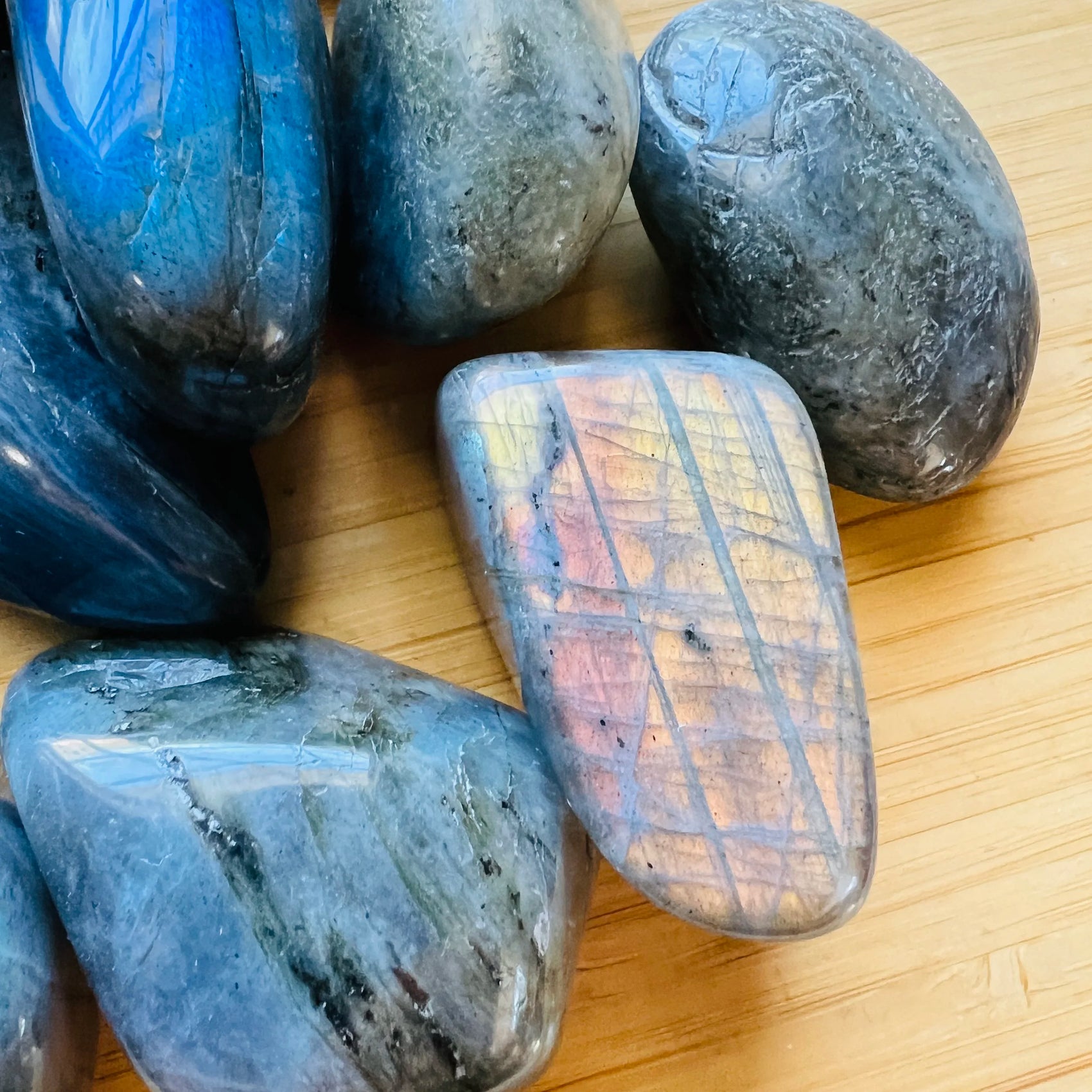 Side-on view of Labradorite tumbled stone, from Madagascar, showing matte finish.
