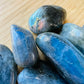 Alternate angle of Grade AA Labradorite tumbled stone, showing characteristic patterning.