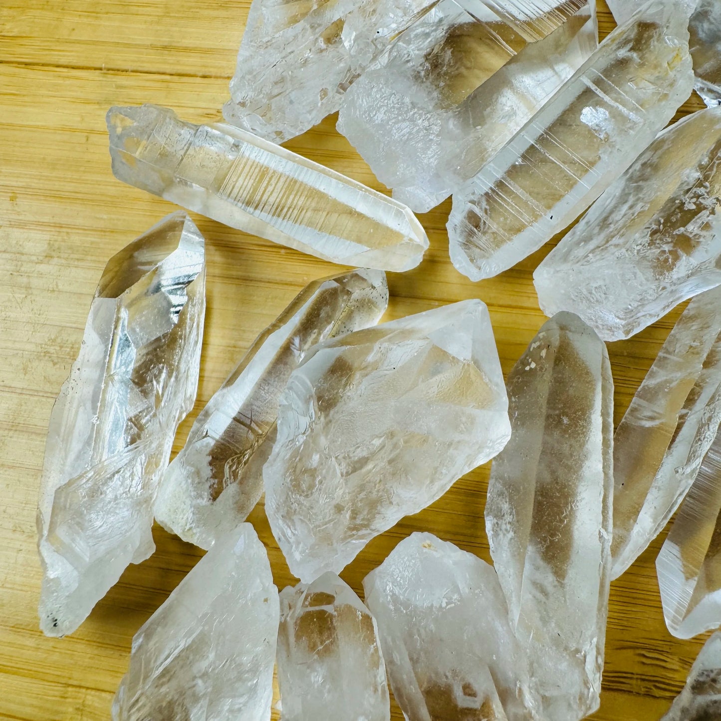 Color detail of Grade AA Lemurian Quartz raw point, showing natural inclusions.