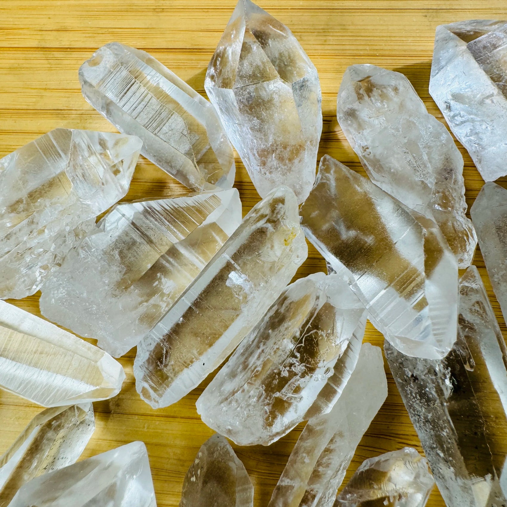 Side-on view of clear Lemurian Quartz raw point, showing characteristic finish.