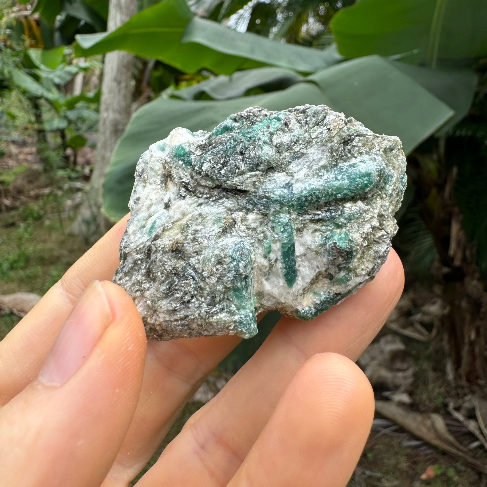 Grade aa emerald specimen held in hand for size reference