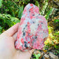 Top angle of Rhodonite specimen, showing natural inclusions.