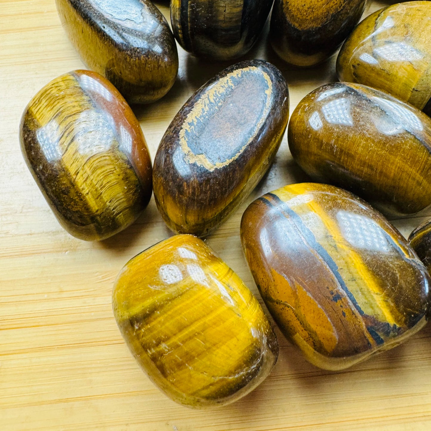 Tight crop of Tiger Eye tumbled stone, showing characteristic color.