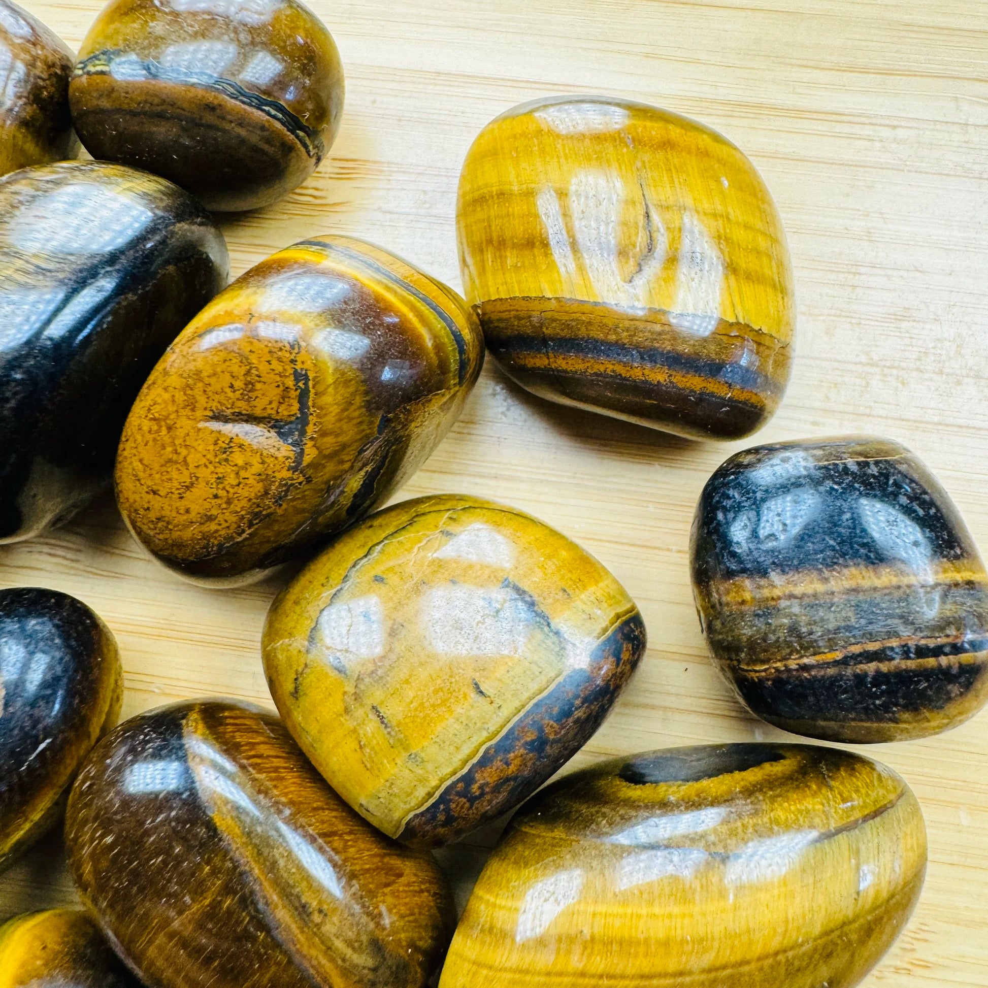 Top-side view of Tiger Eye tumbled stone, hand-selected from Northern Cape, South Africa, showing earthy tone.