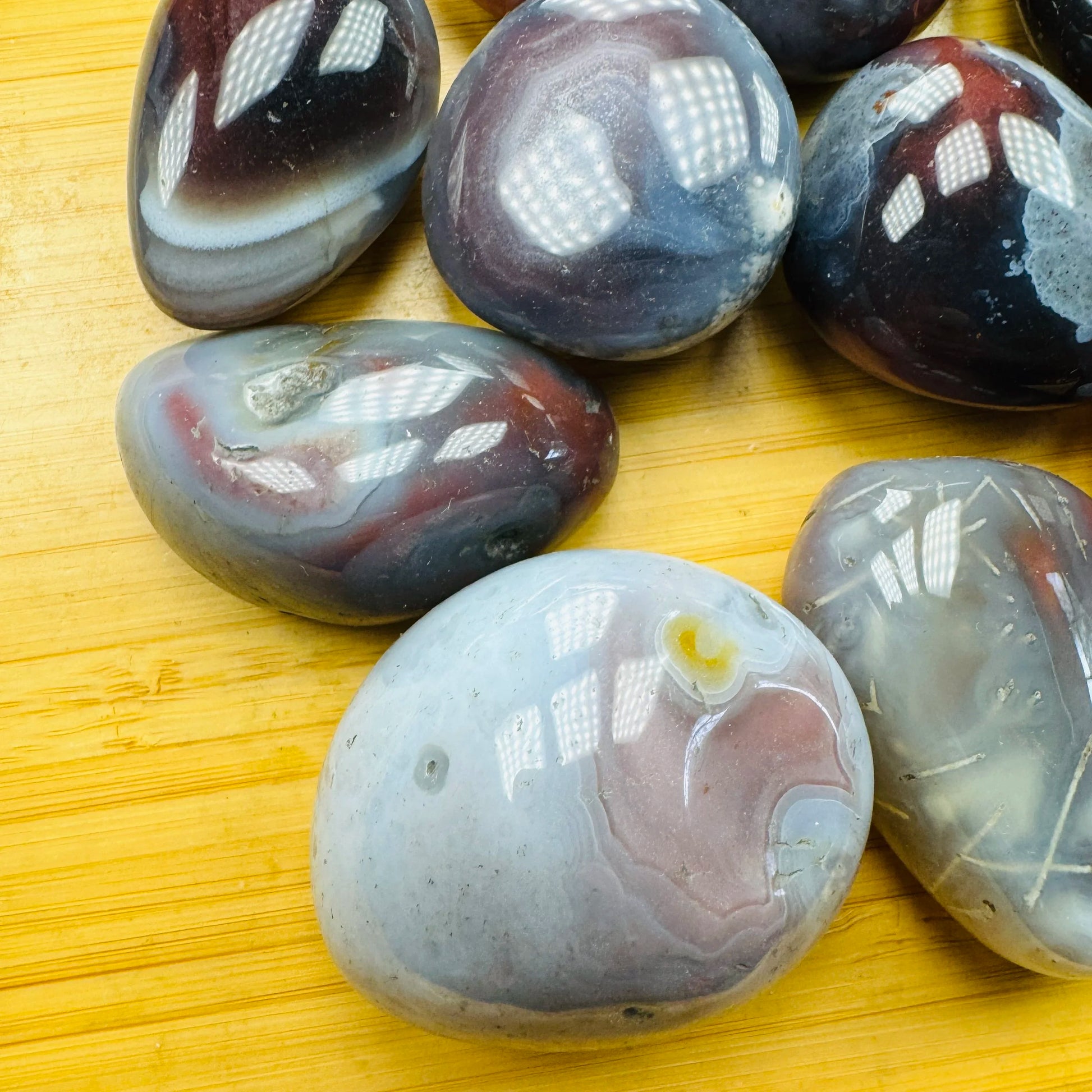 Back view of Grade AA Red Agate tumbled stone showing natural surface