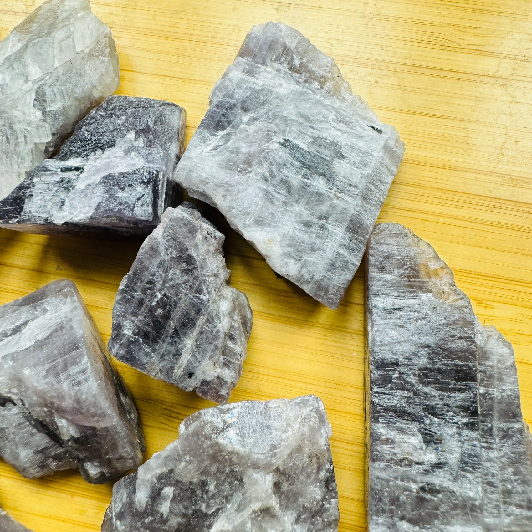 Grade aa anhydrite raw held in hand for size reference