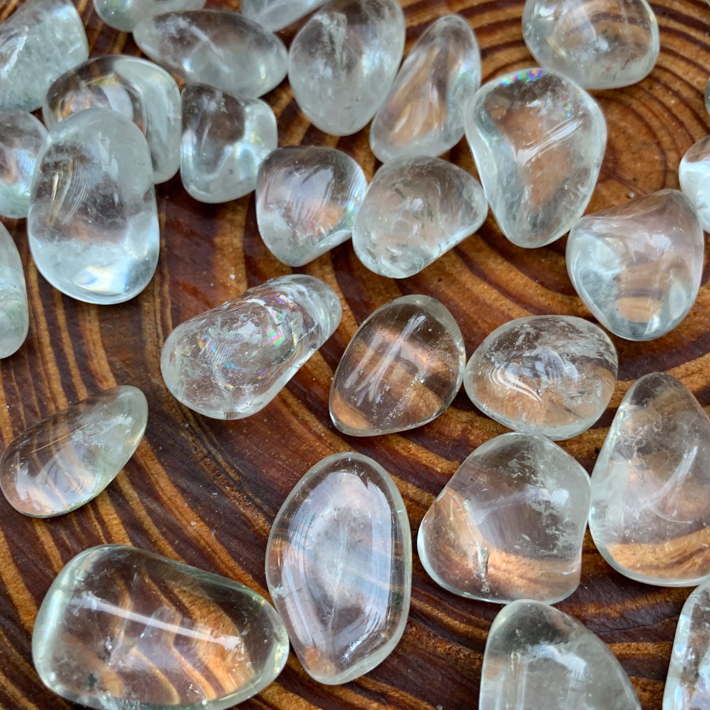 Detail shot of Grade AAA Clear Quartz tumbled stone under natural light