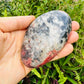 Detail shot of Grade AA Rhodonite freeform under natural light