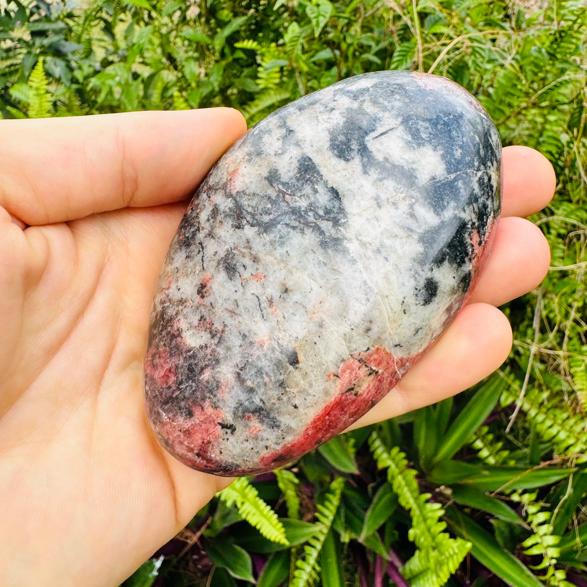 Detail shot of Grade AA Rhodonite freeform under natural light