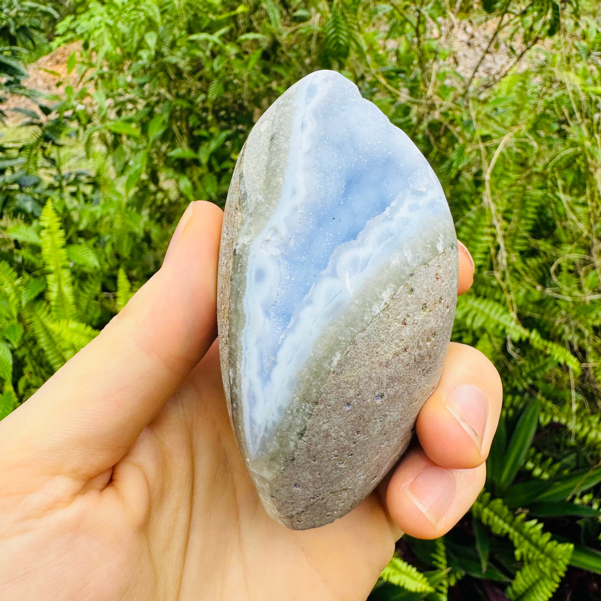 Resting display of Blue Lace Agate specimen, shown for size reference.