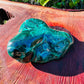 Set against a soft backdrop is a Malachite specimen, linked to Protection, set to give a sense of weight.