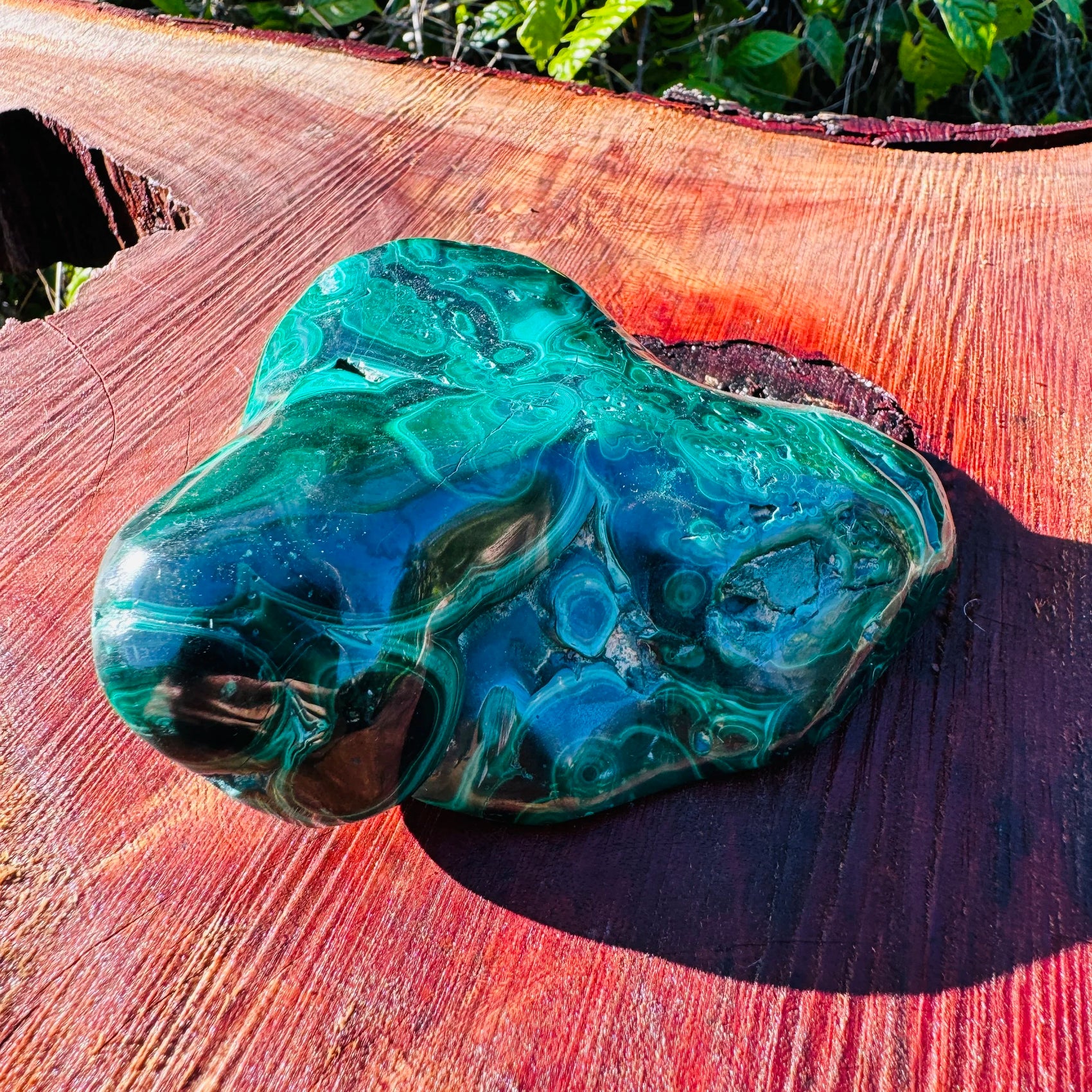 Set against a soft backdrop is a Malachite specimen, linked to Protection, set to give a sense of weight.