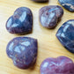 Side profile of Blue Rose Quartz polished heart, showing matte finish.