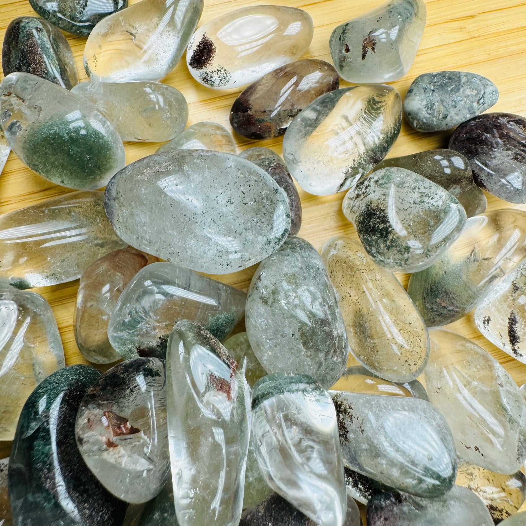Reverse side of Lodolite tumbled stone, showing natural sheen.