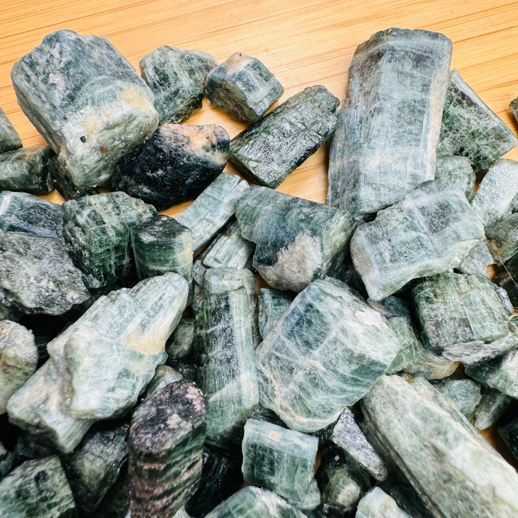 Size comparison with one Diopside raw stone for scale, from Copperbelt Province, Zambia.