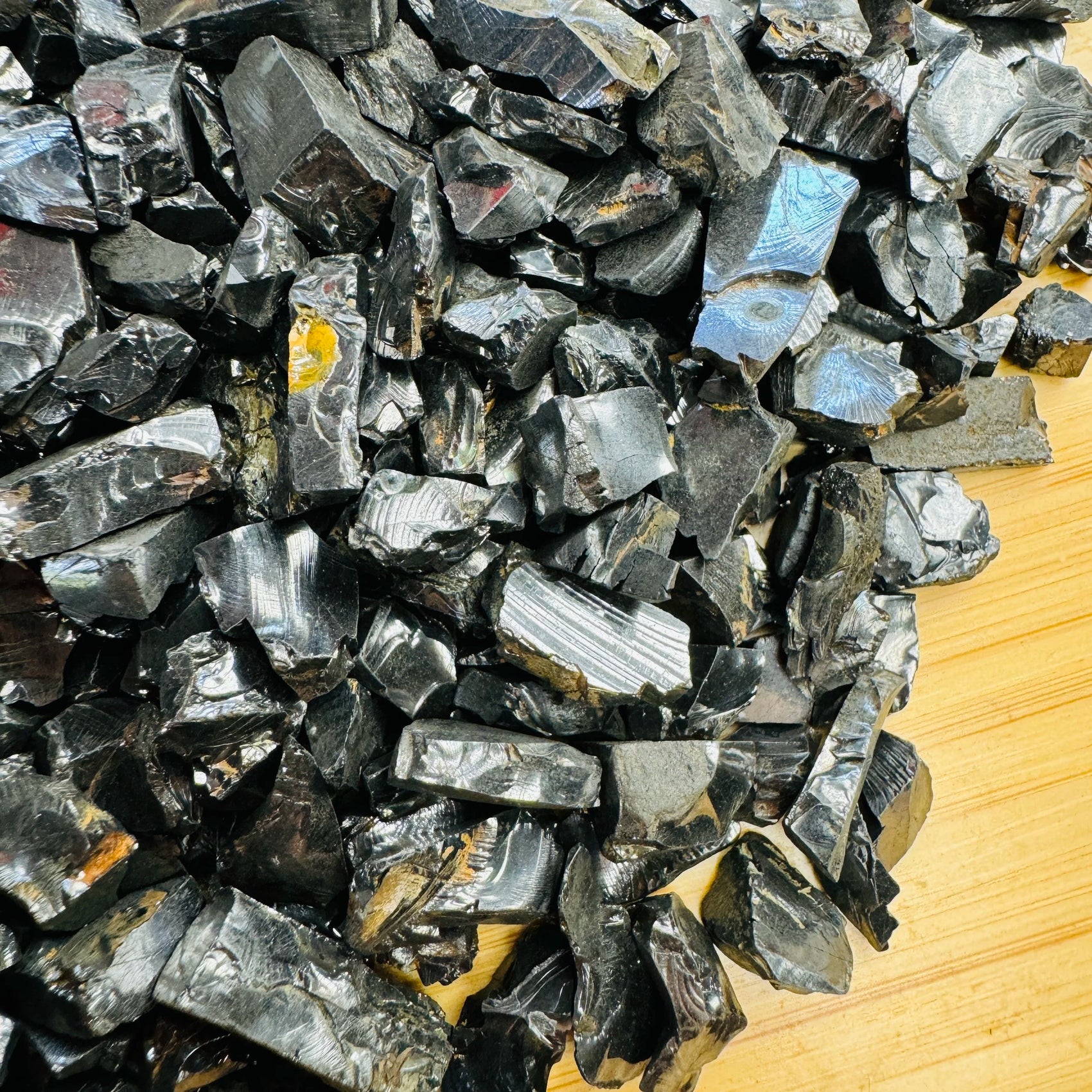 Underside view of black Shungite raw stone, showing natural variation.