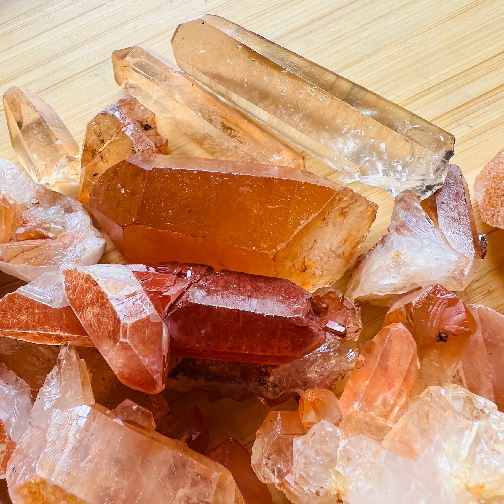 Palm-scale view of a Tangerine Quartz raw point, sourced from Brazil.