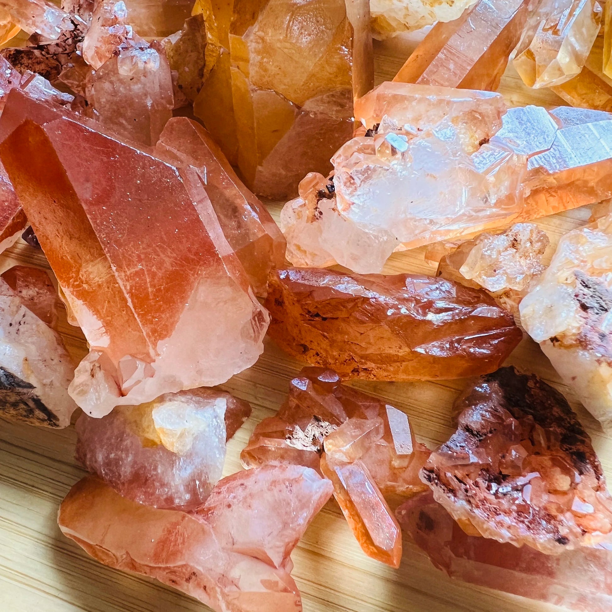 Grade aa tangerine quartz point held in hand for size reference