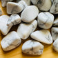 Detail capture of Howlite tumbled stone, showing natural inclusions.