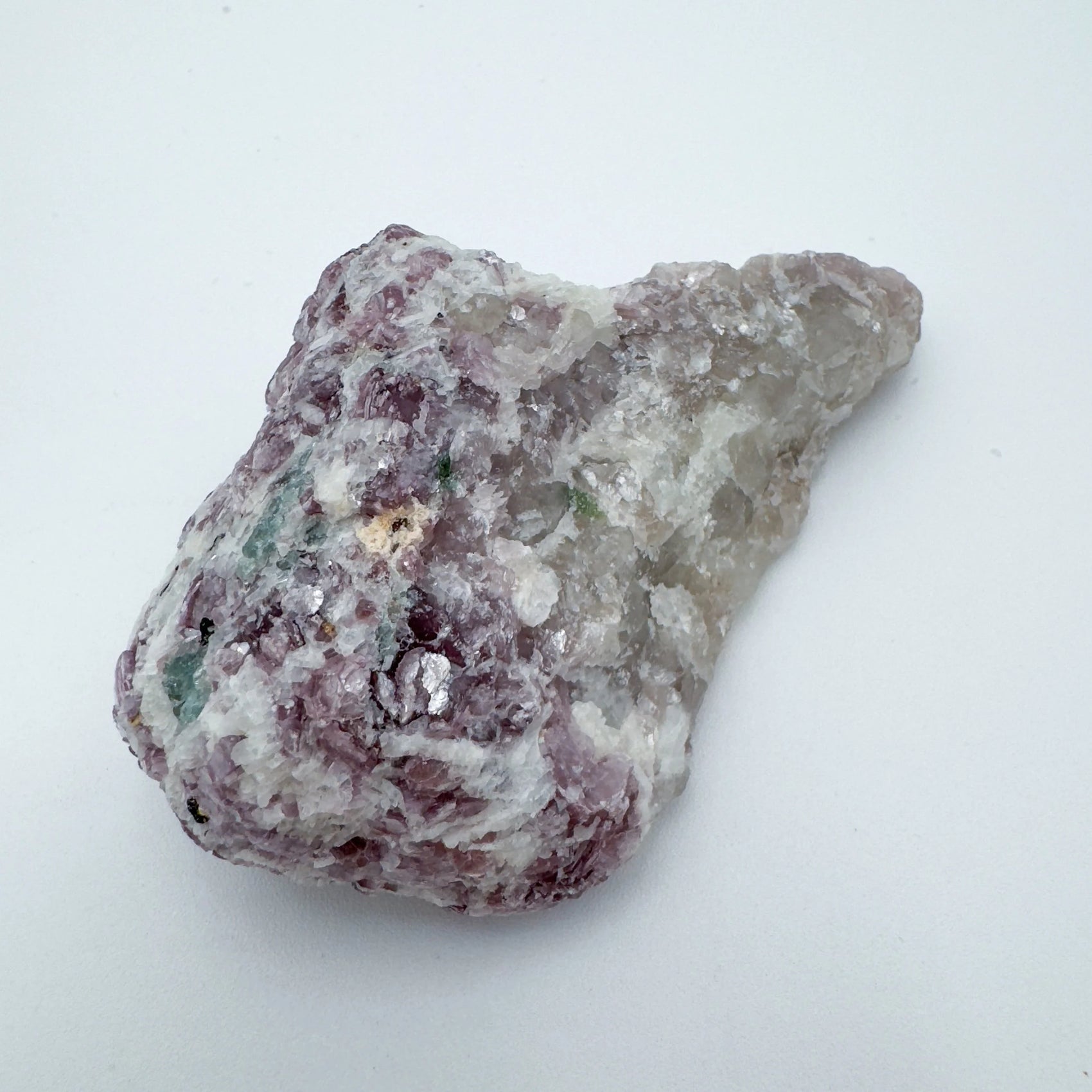 Hand-held view of a Lepidolite specimen often worked with for Stress Relief.