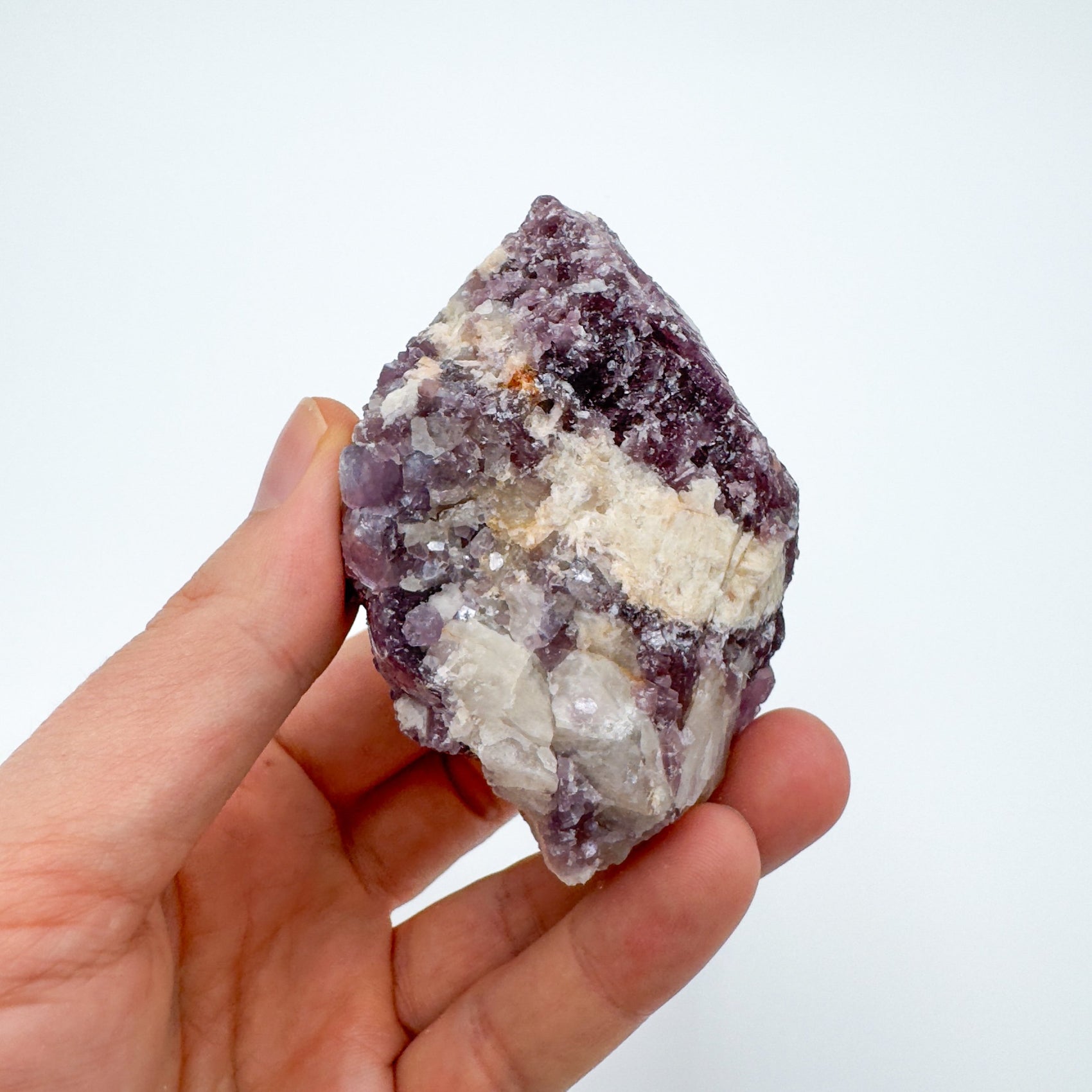 Whole-piece view of Lepidolite specimen, from Minas Gerais, Brazil, often kept for Stress Relief, set to give a sense of weight.