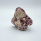 Sideways view of Lepidolite specimen, linked to Stress Relief and Emotional Healing, showing earthy tone.