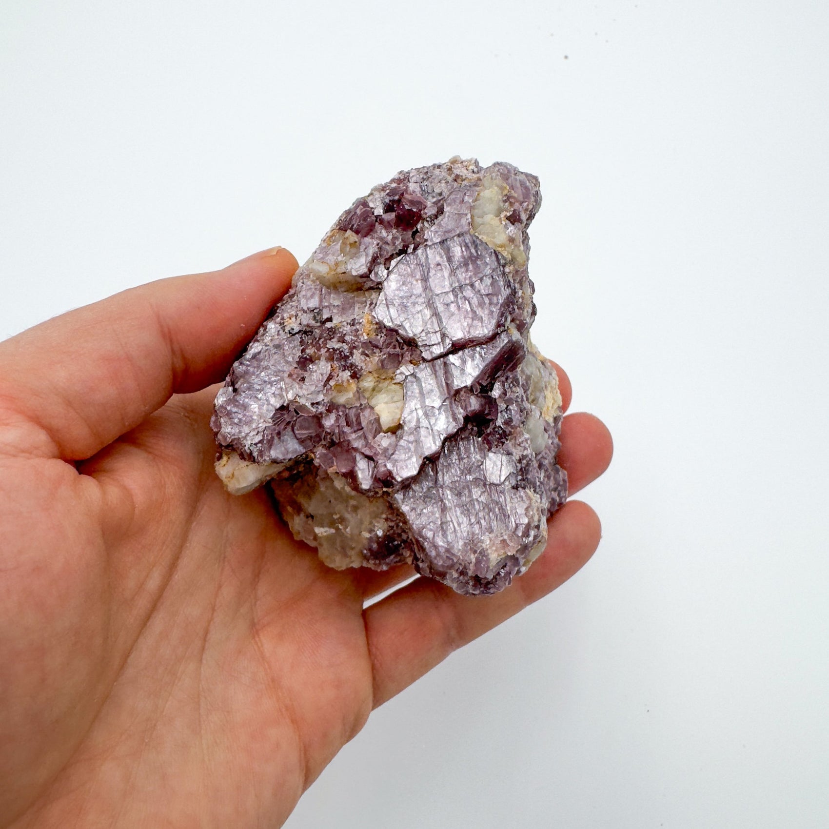 Resting display of Lepidolite specimen, from Minas Gerais, Brazil, associated with Emotional Healing, shown for shape and scale.