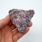 Palm-scale view of a single Lepidolite specimen from Brazil.