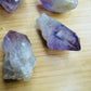 Grade a amethyst point held in hand for size reference