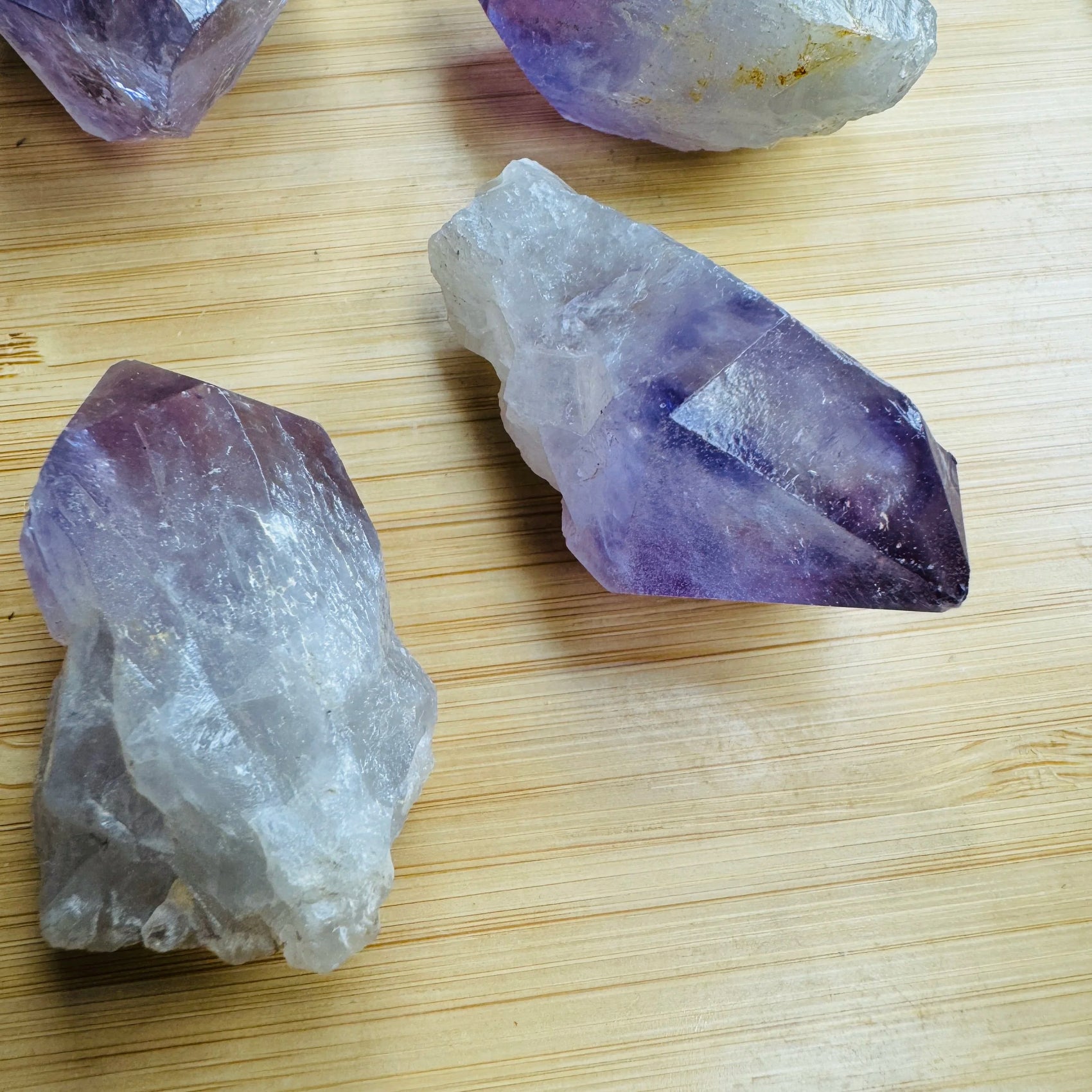 Grade a amethyst point held in hand for size reference
