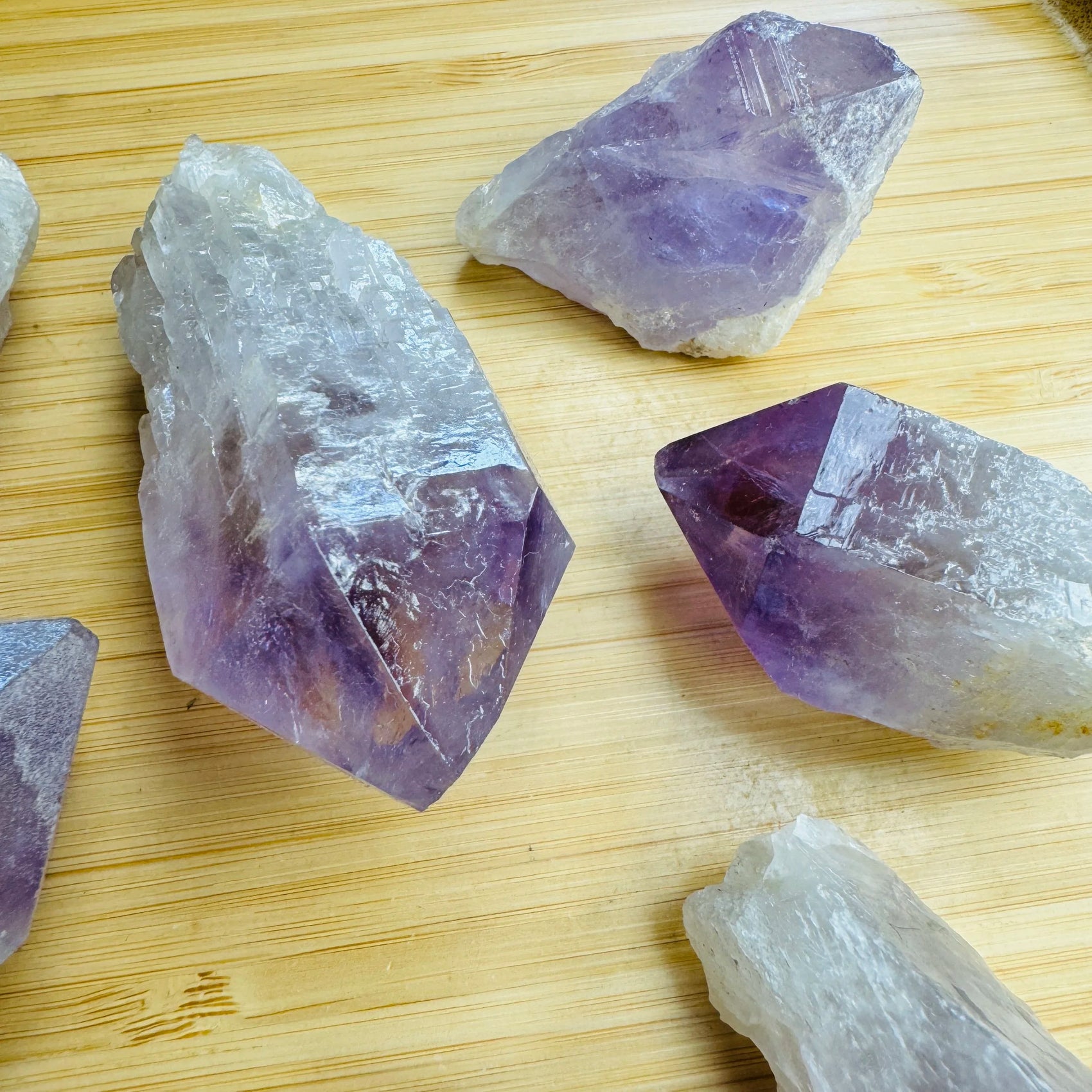 Palm-scale view of a single Amethyst raw point hand-selected from Southern Province, Zambia.