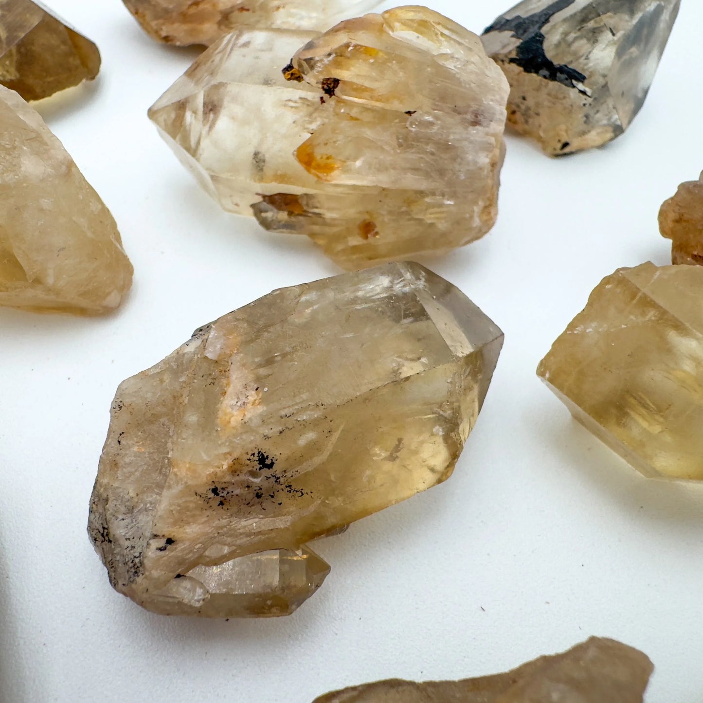 Hand-held view of a Natural Citrine raw stone to support Abundance and Manifestation.